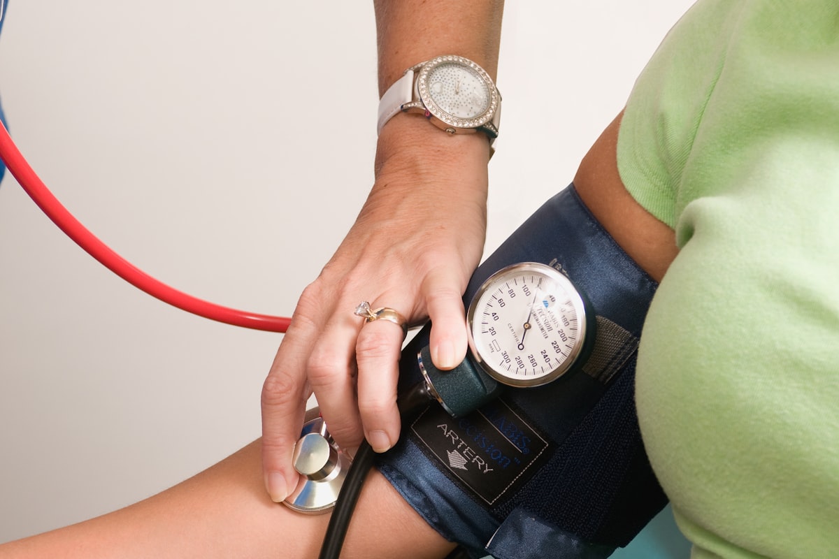 Doctor checking blood pressure of a patient with a stethoscope