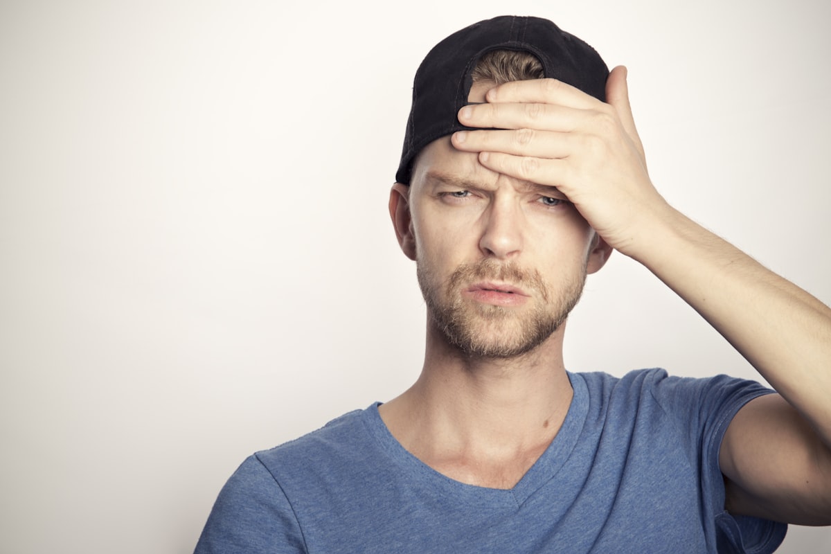 Person holding their head experiencing a severe headache