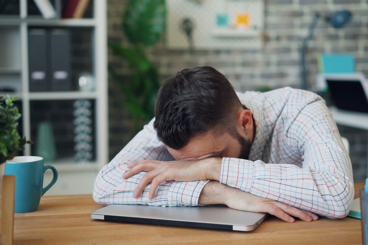 Exhausted person resting their head showing fatigue