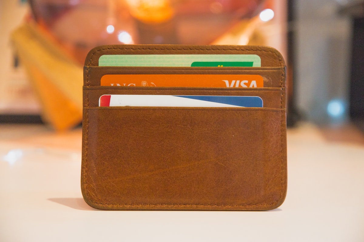 Brown leather wallet with cash representing personal savings