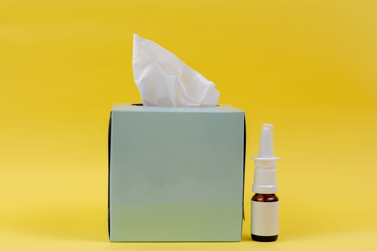 Person sneezing outdoors during allergy season