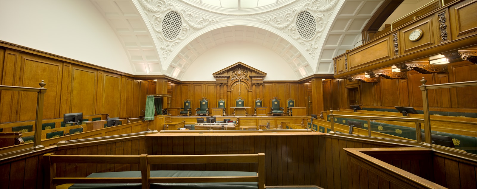 Empty courtroom with wooden paneling where a traffic ticket lawyer would argue a case
