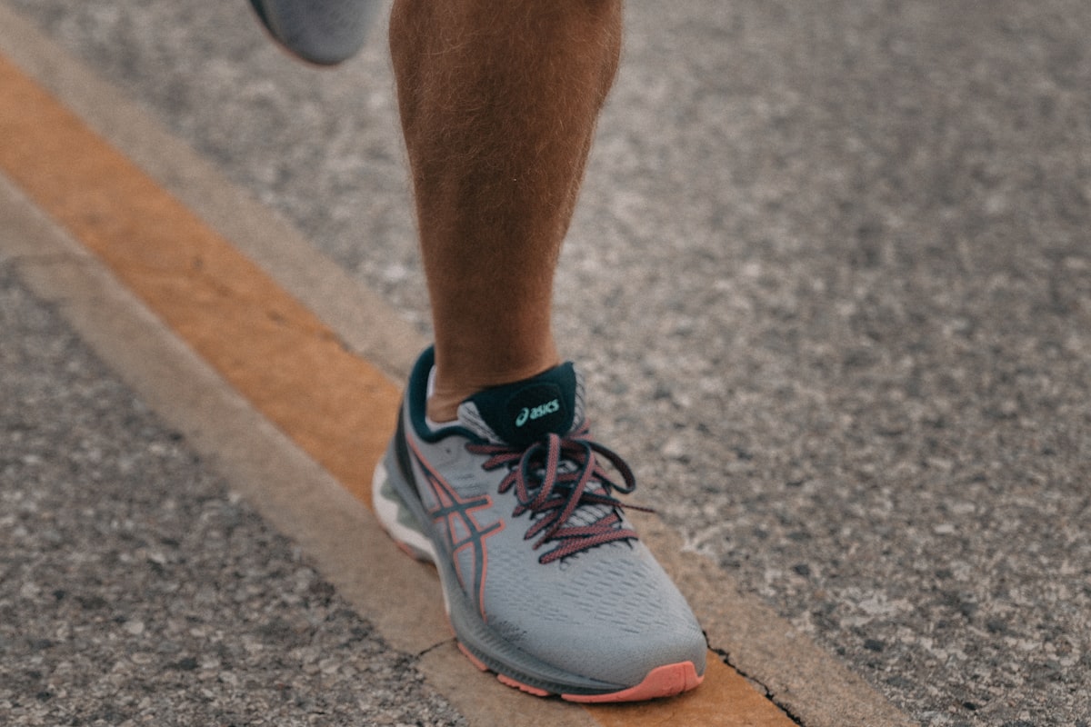 Runner holding their knee in pain during exercise